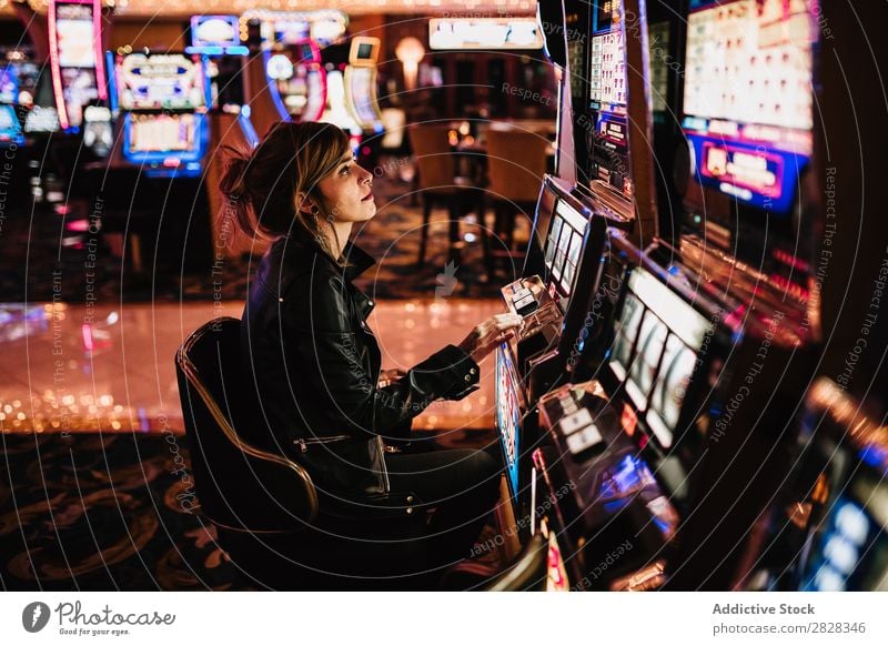 Woman playing slot machine gambling Gaming machine Casino Playing Risk luck Player Success gaming gamble Gambler lucky Night life fortune Excitement Opportunity