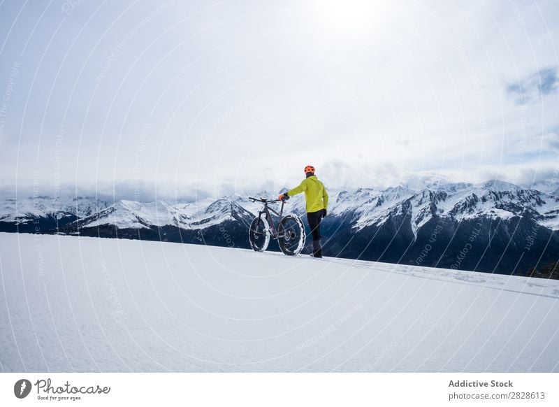 Tourist with bike in mountains Walking Winter Mountain Bicycle sportsman Professional Frozen Nature Hiking Vacation & Travel Landscape Cold Snow Adventure hiker