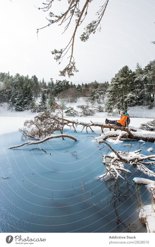 Woman sitting in winter forest Tourist Forest Sit Trunk Winter Lake Frozen Nature Hiking Walking Vacation & Travel Landscape Cold Snow Adventure hiker Lifestyle
