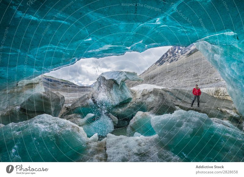 Inside of ice cave and traveler outside Cave Ice Coast Human being Posture Traveling Adventure Formation national Glacier Rock Clear scenery Interior shot