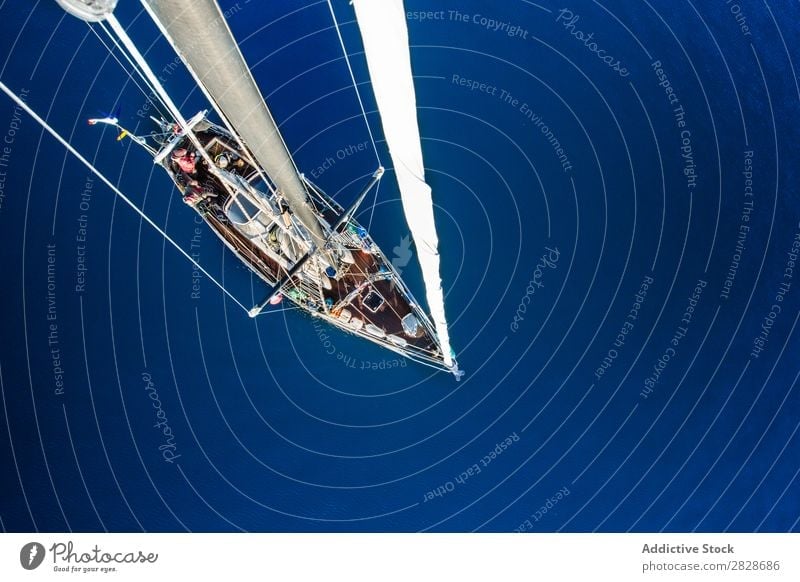 From above shot of sailboat Sailboat Floating Canvas Vessel Yachting Transport Ocean Blue Adventure Vacation & Travel Nautical Water marine Freedom Watercraft