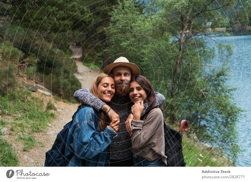 Happy friends in mountains Woman Man Mountain Joy Posture Together Smiling Hiking Lake Water embracing Cheerful Vacation & Travel Adventure Tourist