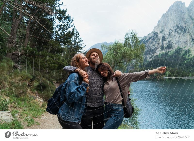 Happy friends in mountains Woman Man Mountain Joy Posture Together Smiling Hiking Lake Water embracing Cheerful Vacation & Travel Adventure Tourist