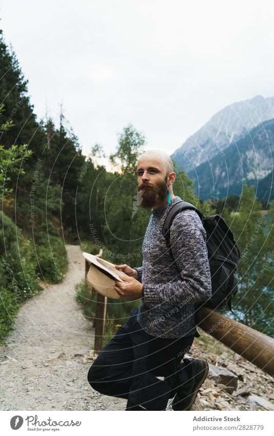Handsome tourist at mountain lake Tourist Man Lake handsome bearded Nature Fence Wood Vacation & Travel Lifestyle Backpack Mountain Landscape Water