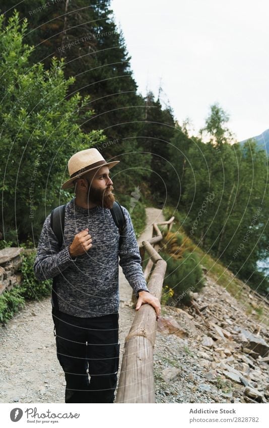 Handsome tourist at mountain lake Tourist Man Lake handsome bearded Nature Fence Wood Vacation & Travel Lifestyle Backpack Mountain Landscape Water