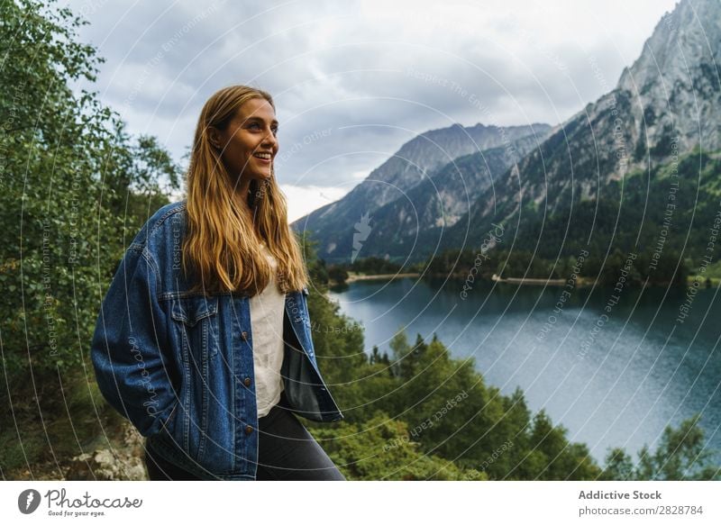 Smiling woman at lake Woman Stone Lake Mountain Nature Landscape Excitement Looking away Water Rock Beautiful Youth (Young adults) Hiking Vacation & Travel