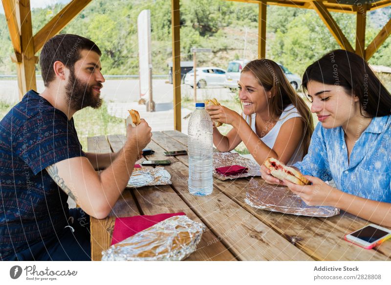 Cheerful friends having meal while traveling Human being Friendship Traveling Vacation & Travel Café Adventure Eating chatting Lunch Summer Food Freedom