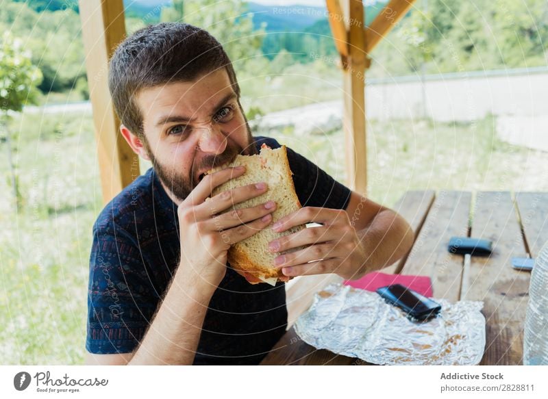 Expressive man with sandwich Man Eating Anger pretend having fun Appetite Crazy Posture facial Intellect Playful Youth (Young adults) bearded Human being