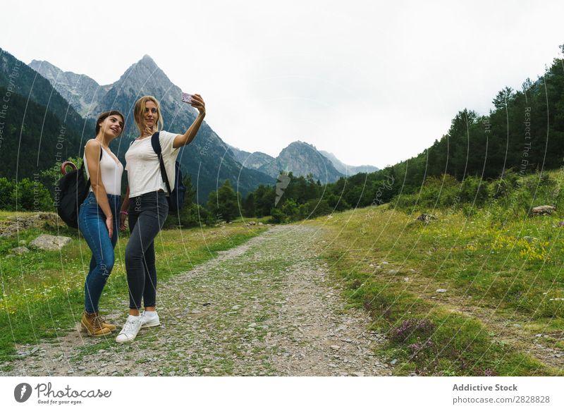 Women taking selfie on mountain road Woman Street Mountain Hiking Vacation & Travel Adventure Tourist Backpack Youth (Young adults) Nature Trip