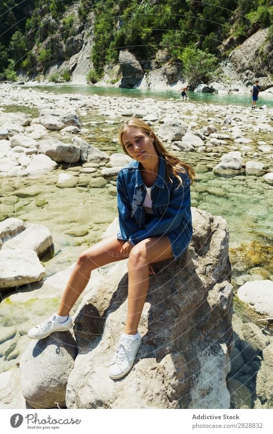 Woman sitting on rocks Summer Mountain Tourism Freedom Rock Happiness Stream Nature Exterior shot Cheerful Vacation & Travel Beautiful Exotic Relaxation