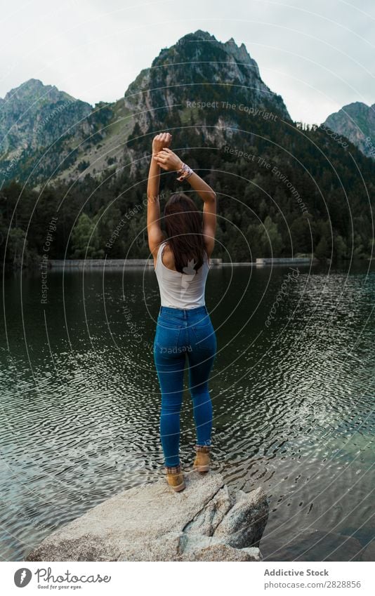 Woman standing on stone at lake Stone Lake Mountain Nature Landscape Water Rock Beautiful Youth (Young adults) Hiking Vacation & Travel Adventure Trip trekking