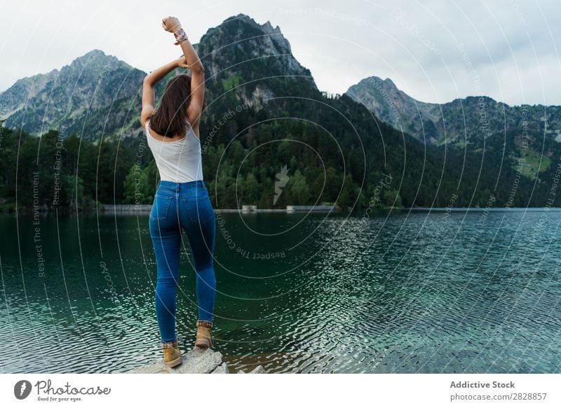 Woman standing on stone at lake Stone Lake Mountain Nature Landscape Water Rock Beautiful Youth (Young adults) Hiking Vacation & Travel Adventure Trip trekking