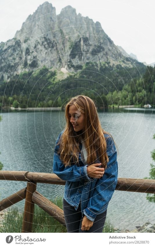 Woman posing at lake in mountains Mountain Smiling Cheerful Happy Hiking Lake Water Vacation & Travel Adventure Tourist Youth (Young adults) Nature Trip
