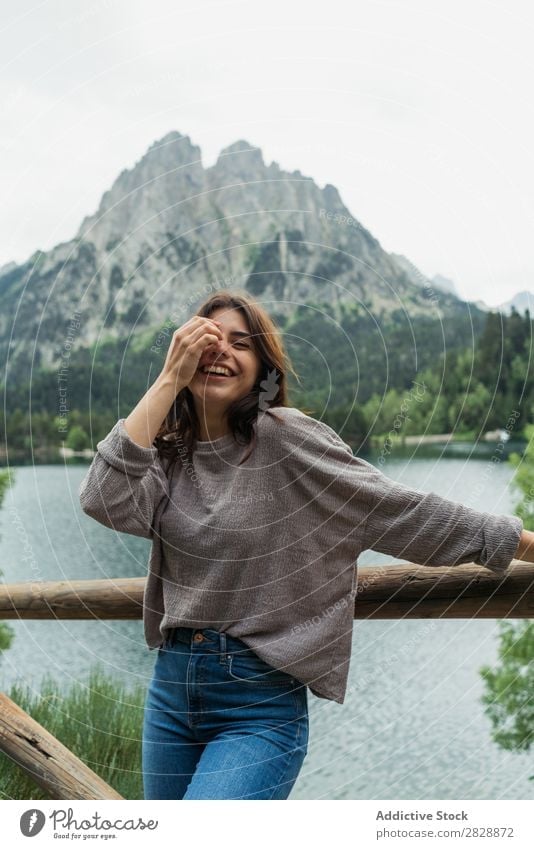 Woman posing at lake in mountains Mountain Smiling Cheerful Happy Laughter Hiking Lake Water Vacation & Travel Adventure Tourist Youth (Young adults) Nature