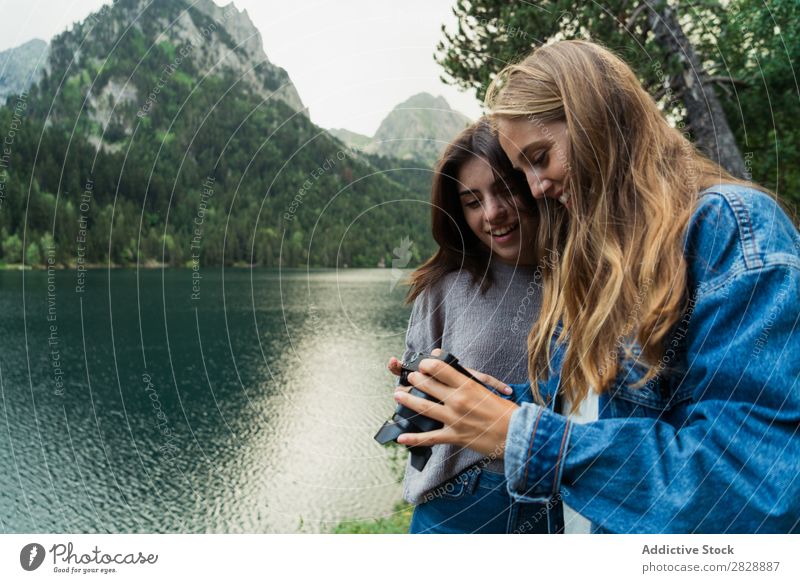 Women with camera in mountains Woman Mountain Walking Camera Photographer Posture Lake Water Take Together Smiling Hiking Cheerful Happy Vacation & Travel