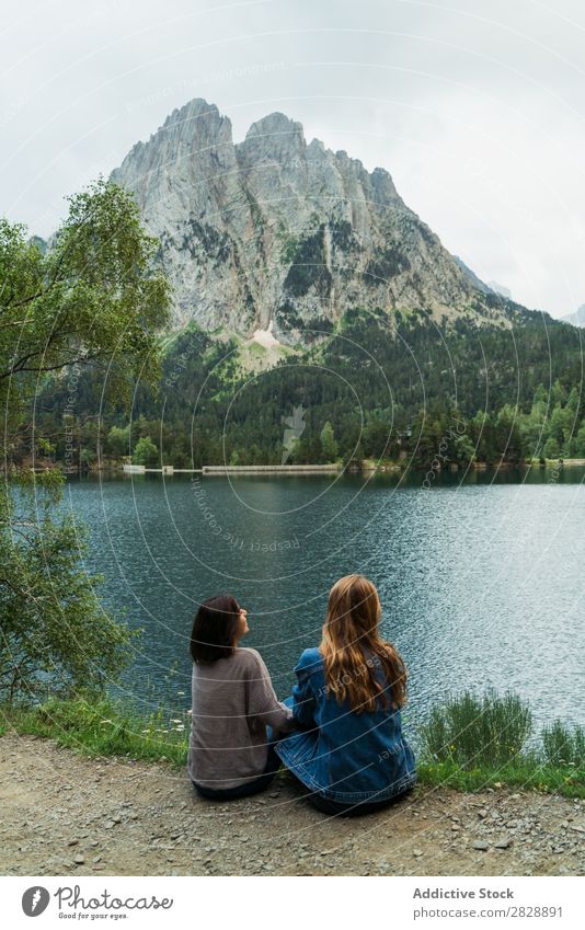 Women sitting at lake Woman Mountain Cheerful Sit Together Hiking Lake Water Vacation & Travel Adventure Tourist Youth (Young adults) Nature Trip