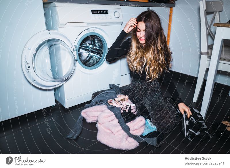 Woman sitting at laundry machine pretty Posture Home Laundry Clothing Sit Kitchen Smiling Beautiful Lifestyle Youth (Young adults) Human being Happy Attractive