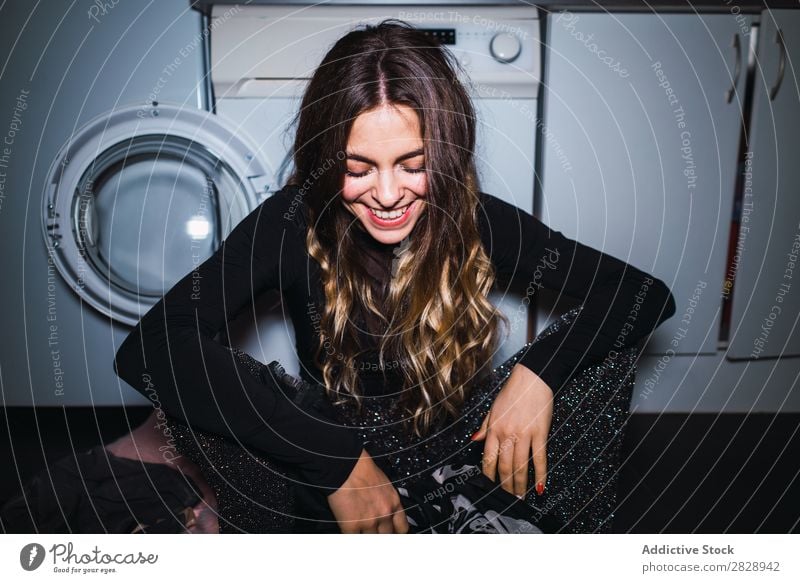 Woman sitting at laundry machine pretty Posture Home Laundry Clothing Sit Kitchen Smiling Beautiful Lifestyle Youth (Young adults) Human being Happy Attractive
