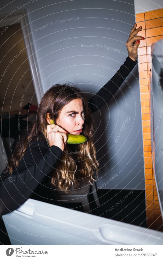 Expressive woman talking on banana as phone Woman Crazy Posture fridge Banana To talk Telephone Youth (Young adults) Beautiful pretty Human being