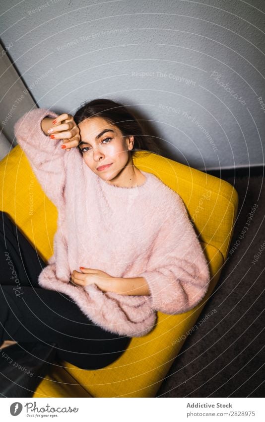 Young woman resting on armchair Woman Youth (Young adults) Attractive Home Sweater Pink Armchair Sit Lie (Untruth) Happy Expressive Posture Alluring Beautiful