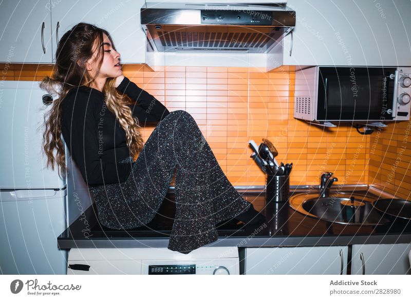 Woman sitting on kitchen table pretty Posture Home Sit Table Kitchen Beautiful Lifestyle Youth (Young adults) Human being Happy Attractive Portrait photograph