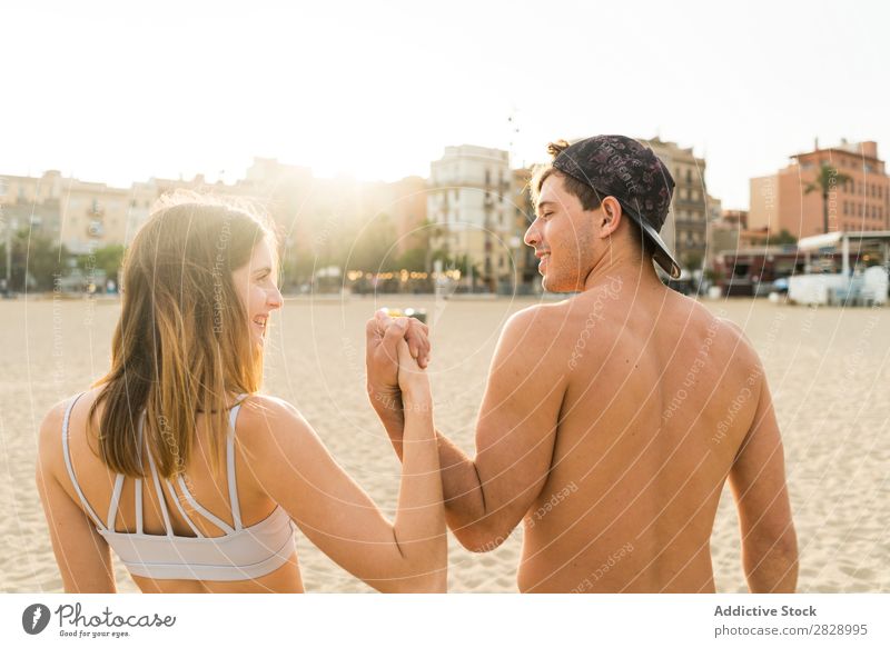 Back view of sportive couple Couple Beach achievement Teamwork Success Athletic Town Gesture Embrace Coast Fitness Landscape City Support shirtless Sportswear