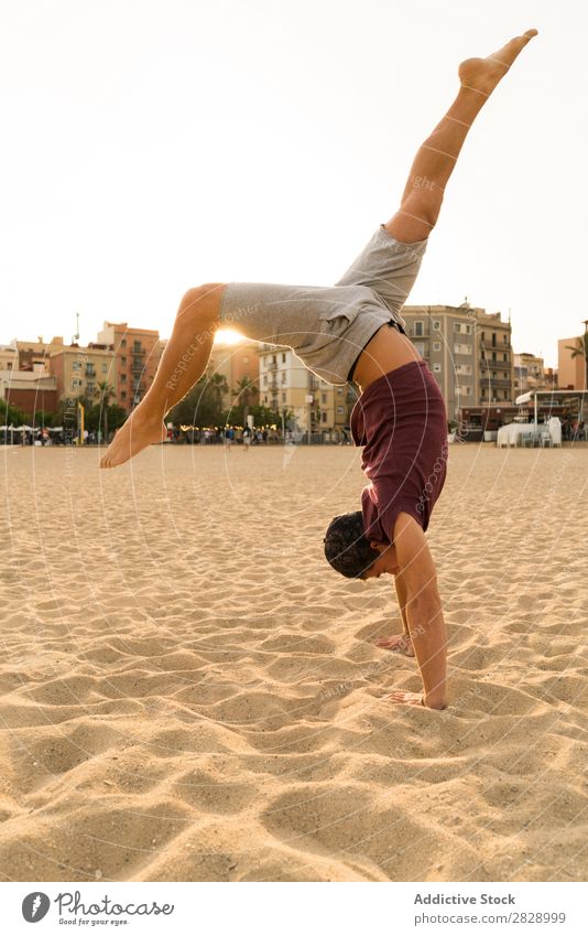 Man In handstand on beach Handstand Beach Sports Practice Fitness Freedom Stand Balance pose Power upside Energy Athlete Easygoing Sunset workout Muscular