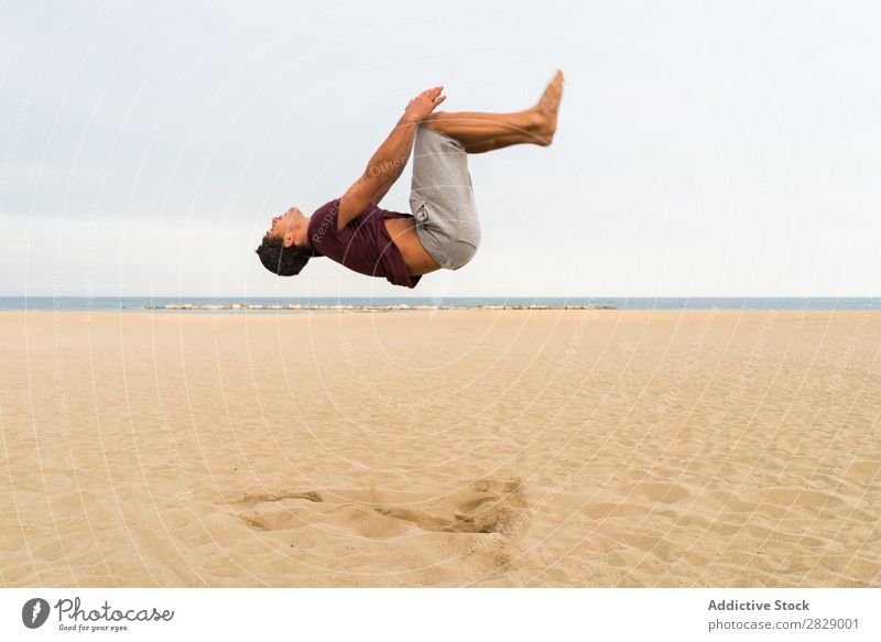 Side view of man in jump Man Beach Athletic flip Jump Sports Practice in motion Fitness Freedom Balance pose Power Energy Athlete Easygoing Sunset workout
