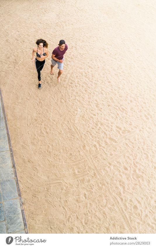 Couple running on beach Human being Athletic Running Beach workout Action Jogging Fitness Coast Runner Together Speed Exterior shot Wellness Sand Movement