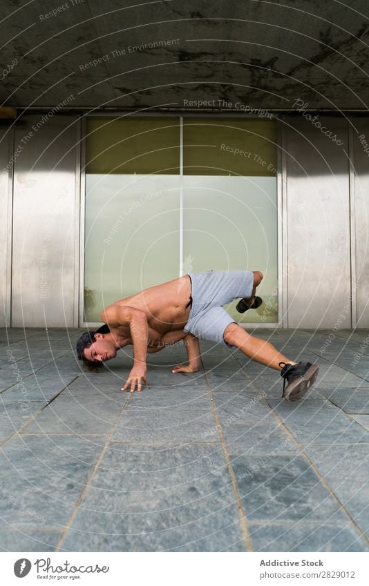 Shirtless man in handstand on street Man Handstand Practice Town Fitness Balance Sports Freedom Endurance Stand pose Power upside Energy Street Strong Athlete