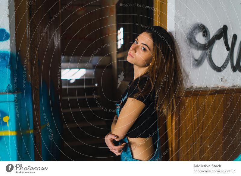 Woman posing in abandoned building Building Cheerful Posture Graffiti Attractive To enjoy Hair Set Youth (Young adults) Portrait photograph Beautiful Lifestyle