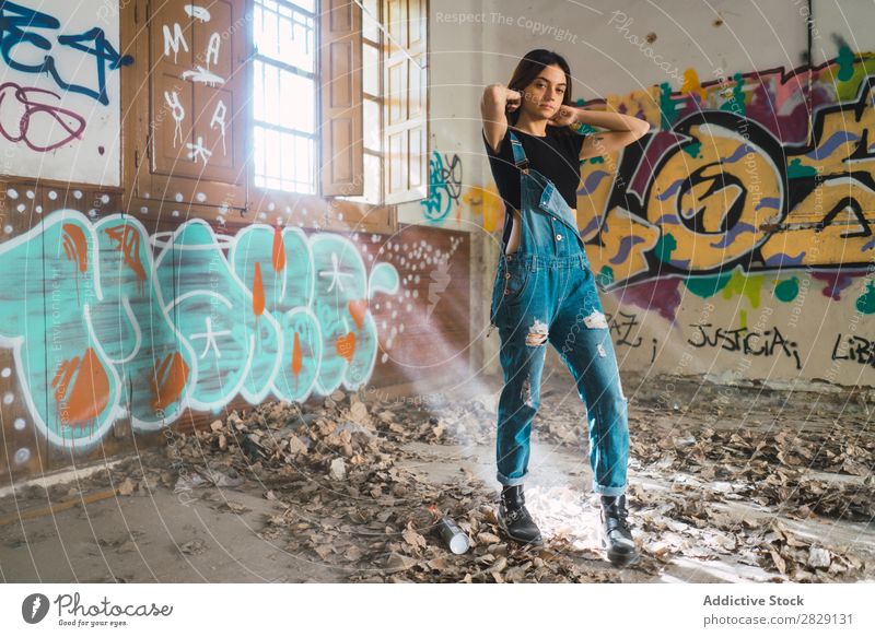 Woman setting hair in abandoned building Building Smiling Cheerful Posture Looking into the camera Graffiti Attractive To enjoy Hair Set Youth (Young adults)