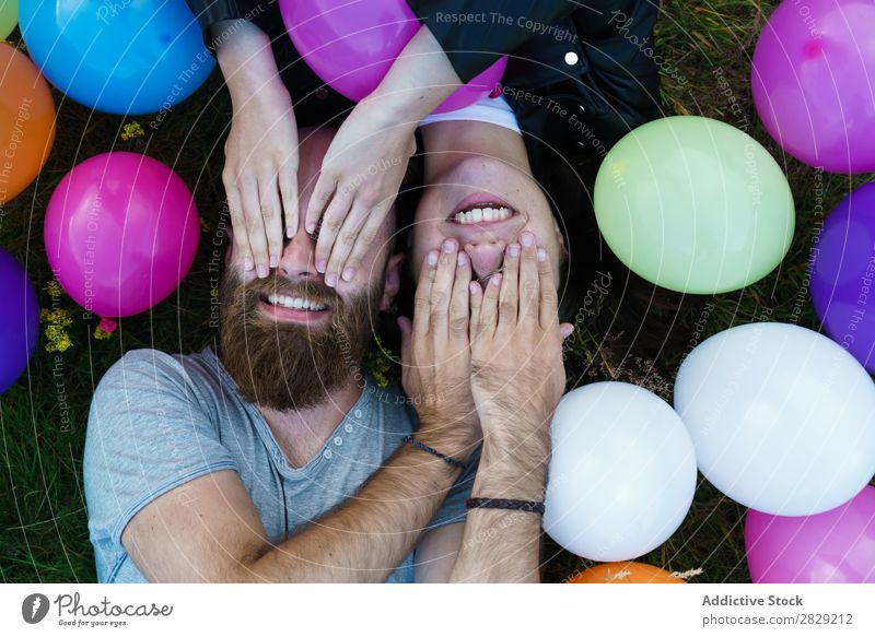 Couple in balloons covering eyes Woman Man Together covering face Smiling Love Nature Friendship Human being pretty handsome bearded Posture Freedom Joy
