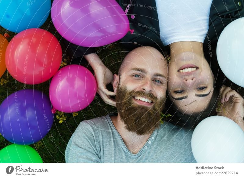Couple having fun in balloons Woman Man Together covering face Smiling Love Nature Friendship Human being pretty handsome bearded Posture Freedom Joy Beautiful