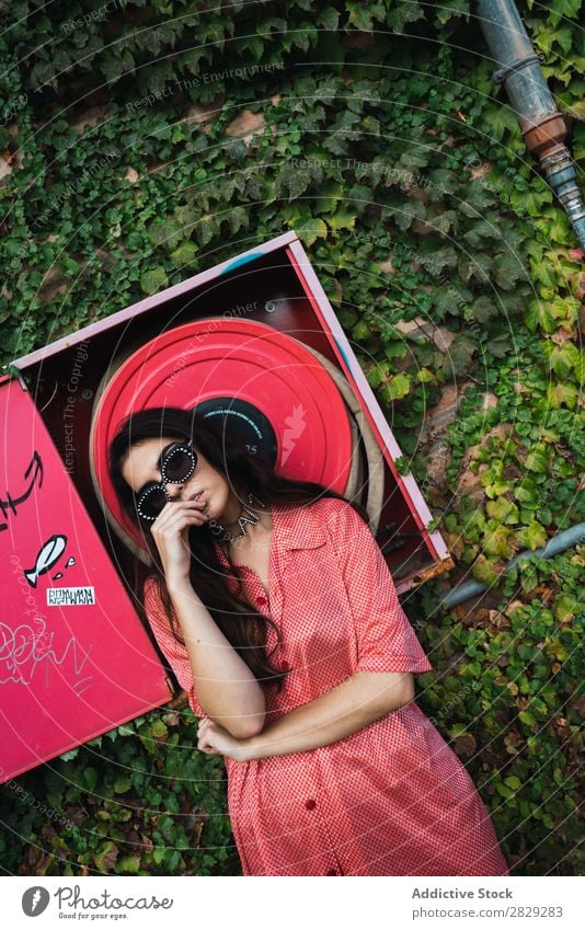 Woman posing at fire hose Style Street Town Fire-fighting tube Red Posture Plant Growth Sunglasses Portrait photograph Attractive Beauty Photography