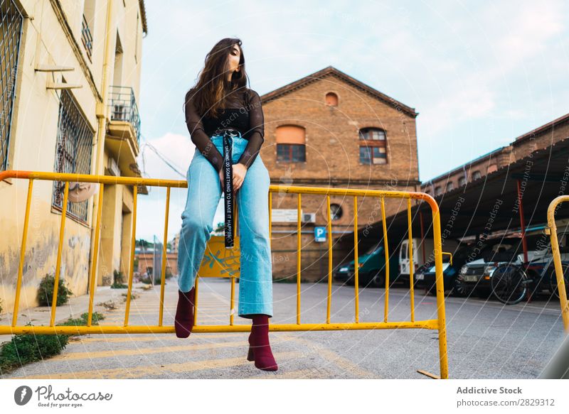 Woman sitting at fence Style Street Town Posture Sit Fence Asphalt Portrait photograph Attractive Beauty Photography Hip & trendy Lifestyle pretty Fashion