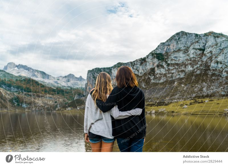 Women standing at lake Woman Meadow Lake embracing Stand Together Friendship Relaxation Mountain Nature Field Girl Grass Beautiful Youth (Young adults) Green