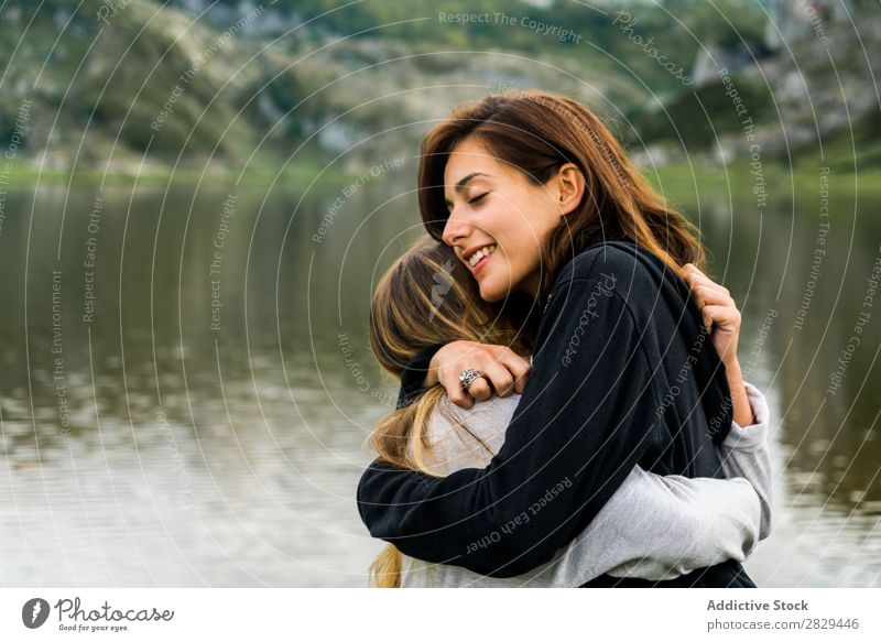 Girls hugging at lake Woman Meadow Lake embracing Stand Together Friendship Relaxation Mountain Nature Field Grass Beautiful Youth (Young adults) Green Spring