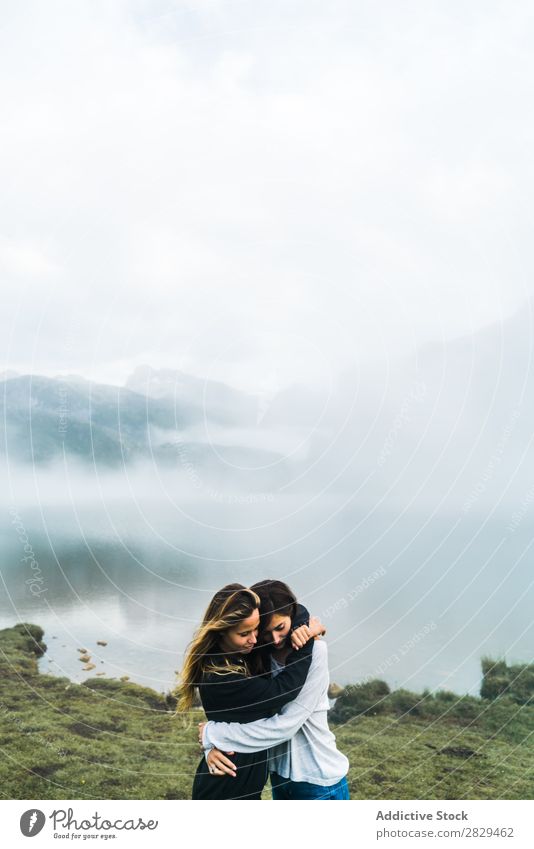 Women at foggy lake Woman Meadow Lake embracing Fog Stand Together Friendship Relaxation Mountain Nature Field Girl Grass Beautiful Youth (Young adults) Green