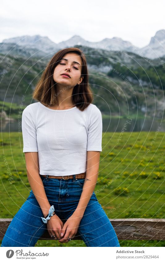 Woman relaxing in mountain meadow Meadow Relaxation Sit Handrail Mountain eyes closed Nature Field Girl Grass Beautiful Youth (Young adults) Green Spring