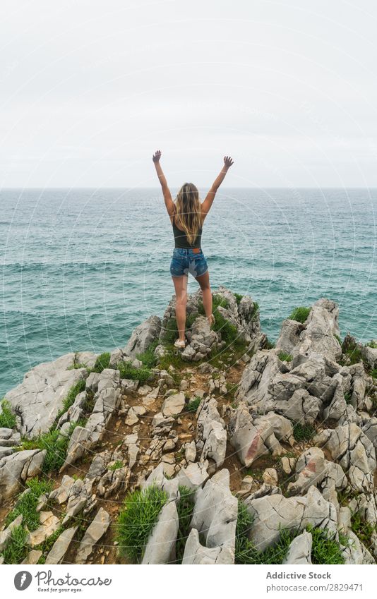 Girl with arms raised standing on the cliff Woman Cliff Ocean Beautiful Rock Summer Nature Vacation & Travel Water Landscape Youth (Young adults) Blue Lifestyle