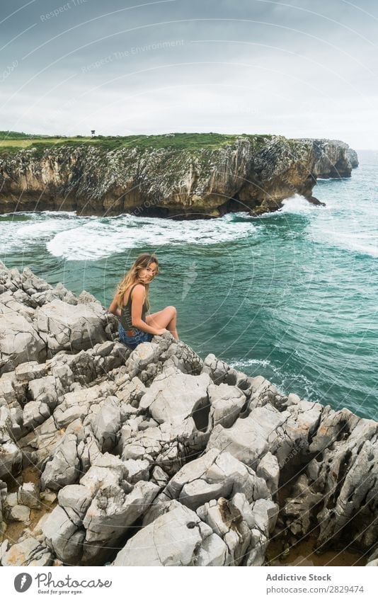 Woman sitting at edge of rock Cliff Ocean Sit Beautiful Rock Summer Nature Vacation & Travel Water Landscape Youth (Young adults) Blue Lifestyle Freedom Hiking