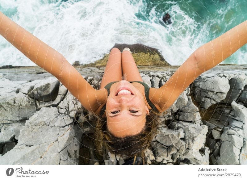 Woman taking selfie at edge of rock Cliff Ocean Sit Beautiful Rock Summer Nature Vacation & Travel Water Landscape Youth (Young adults) Blue Lifestyle Freedom