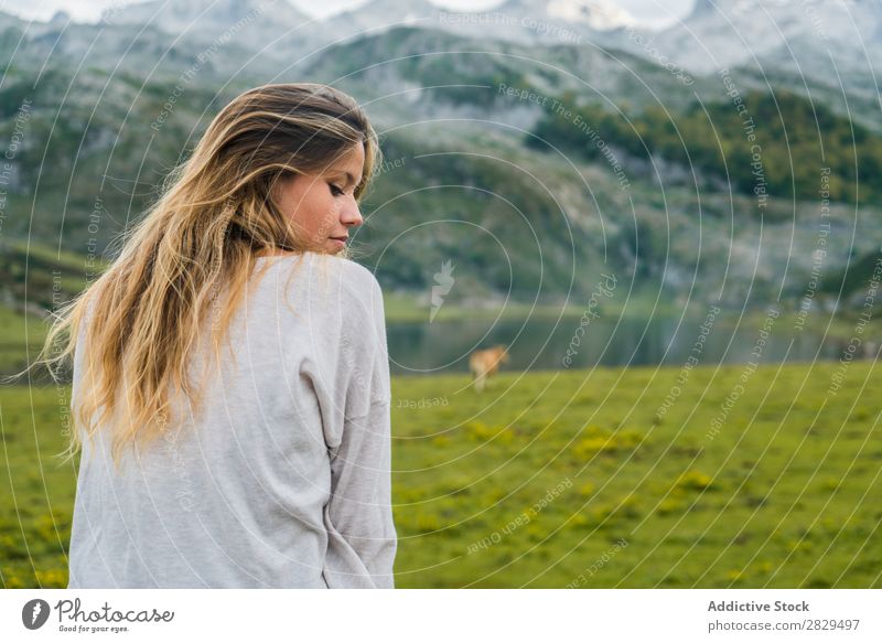 Woman relaxing in mountain meadow Meadow Relaxation Sit Handrail Mountain eyes closed Nature Field Girl Grass Beautiful Youth (Young adults) Green Spring