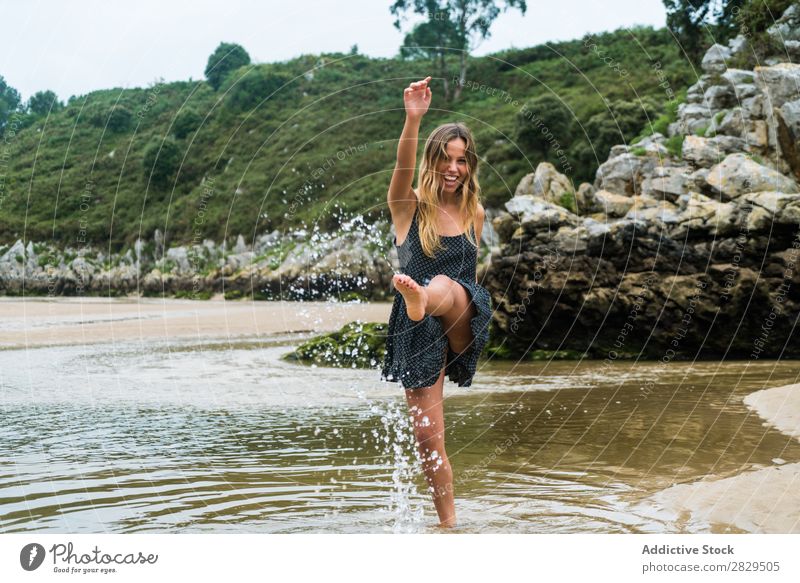 Cheerful girl playing in water Woman Water Beach having fun Splashing Nature Happiness Vacation & Travel Summer Rock Tropical Playing Action Style Playful
