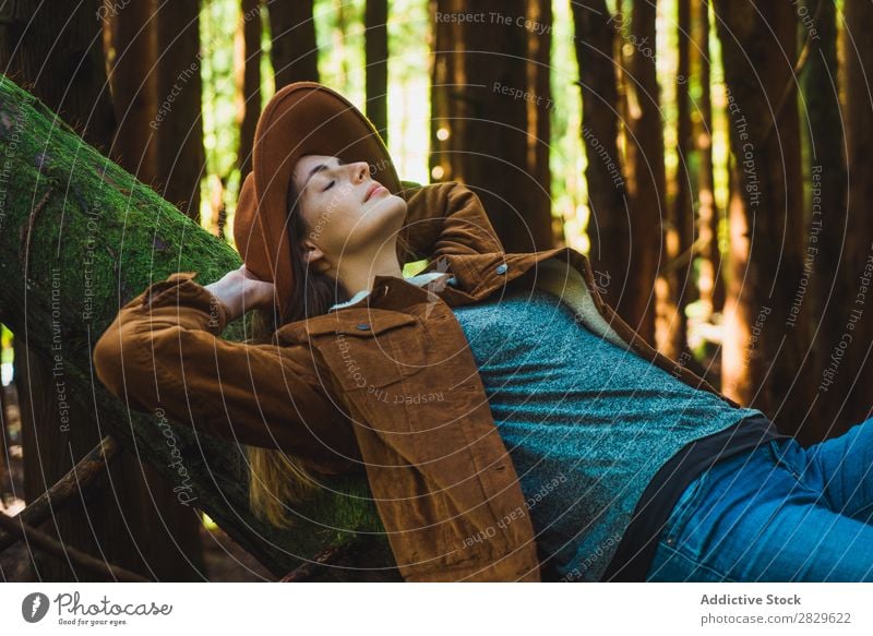 Woman relaxing on tree trunk Tourist Forest Green Nature Lie (Untruth) Relaxation Trunk eyes closed Environment pretty Natural Seasons Plant Leaf Light Fresh