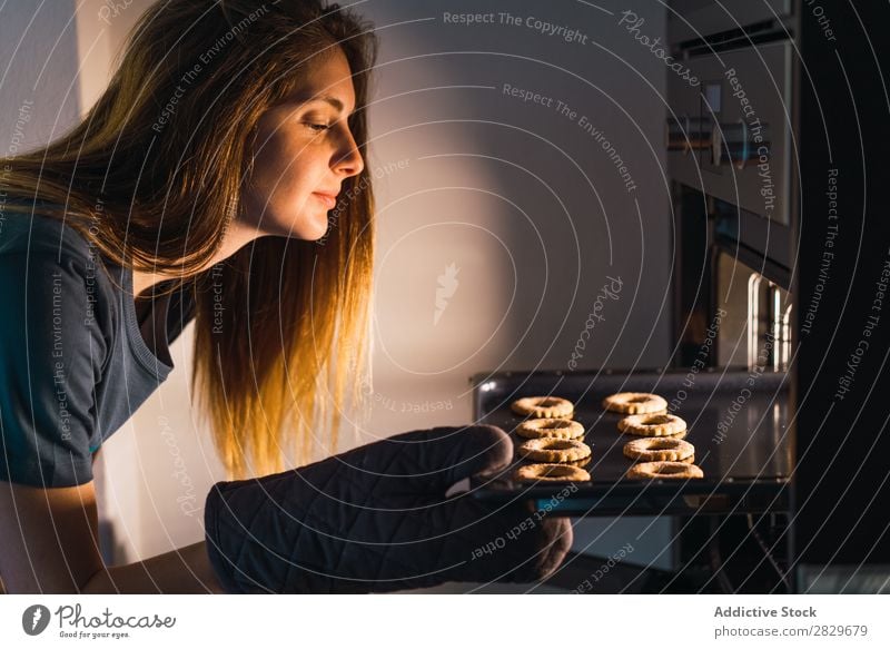 Woman making cookies in oven Stove & Oven Cookie Baking Preparation checking sheet pan Fresh Tray Make Confectionary Flat (apartment) Kitchen Bakery Baked goods