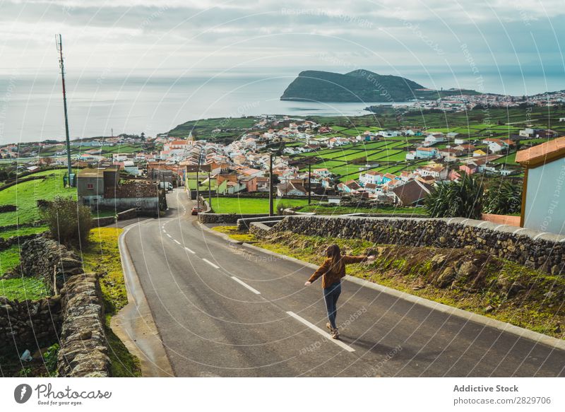 Woman enjoying freedom on coastal road Town Coast Freedom Ocean Panorama (Format) Street Joie de vivre (Vitality) romantic Walking hands apart tranquil seascape