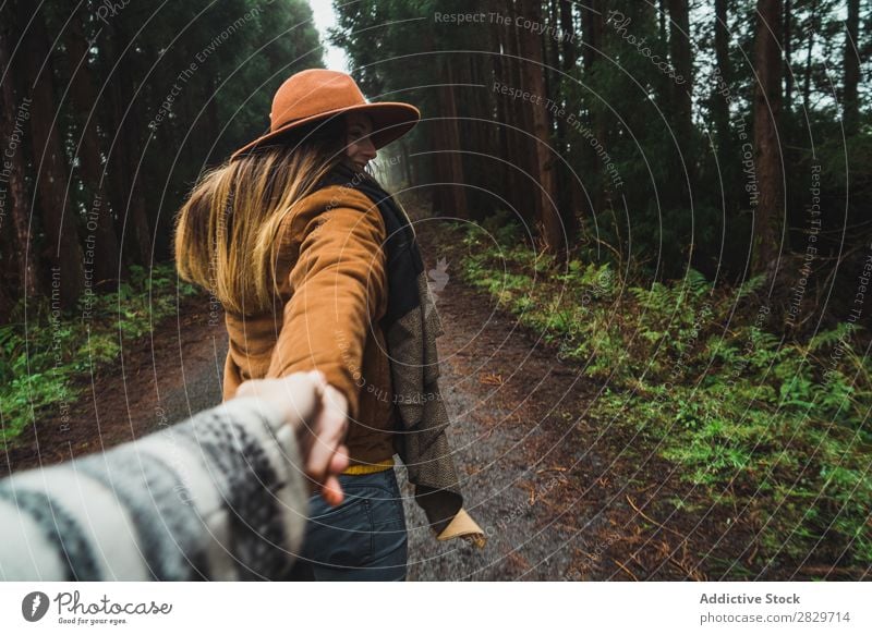 Woman holding hand of photographer in woods Forest follow me romantic Together holding hands Street enchanted Wilderness Lush Plant Cheerful leading Jacket