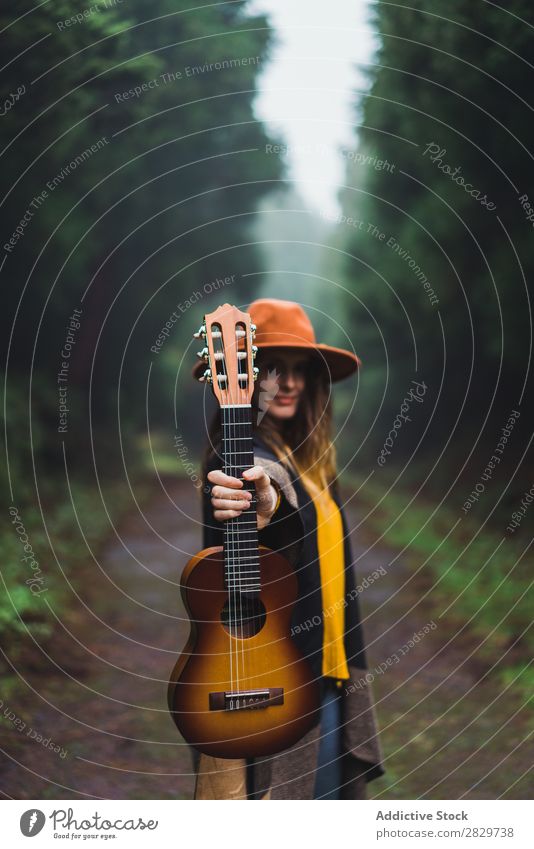 Woman showing ukelele in woods Forest Happiness Freedom Fog Ukulele traveler Expression Excitement Movement romantic Energy Trip Cold above ground Relaxation